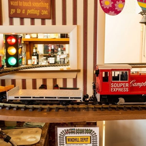 A model train, the "Souper Campbell's Express," on a track in a whimsical restaurant setting.